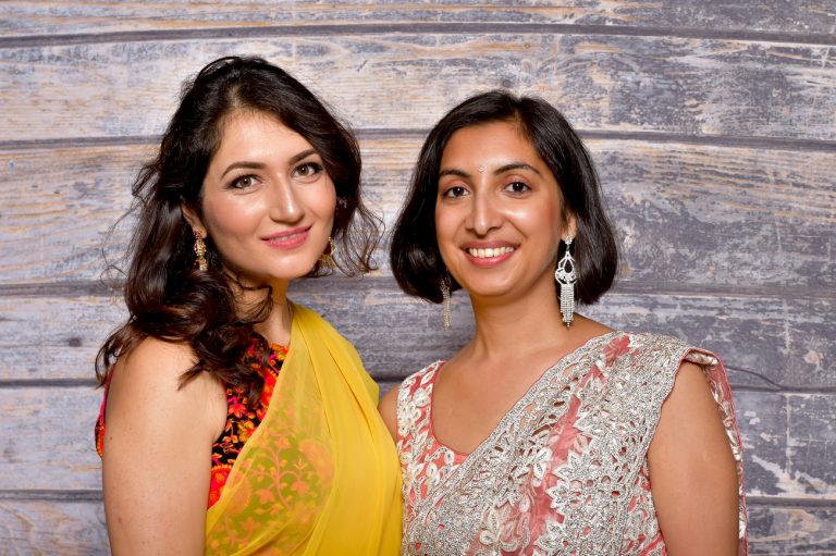 Two womens in a photo frame of Opens photo booths